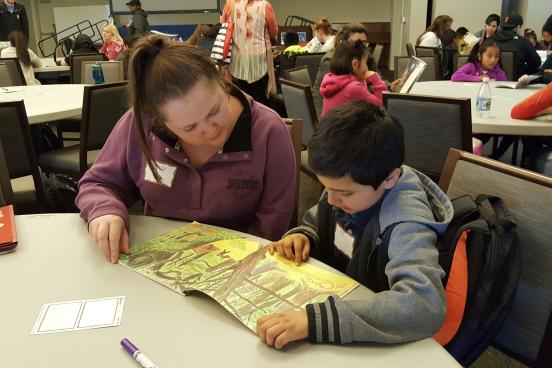 Meadow View student reading to a Sonoma State service-learner.