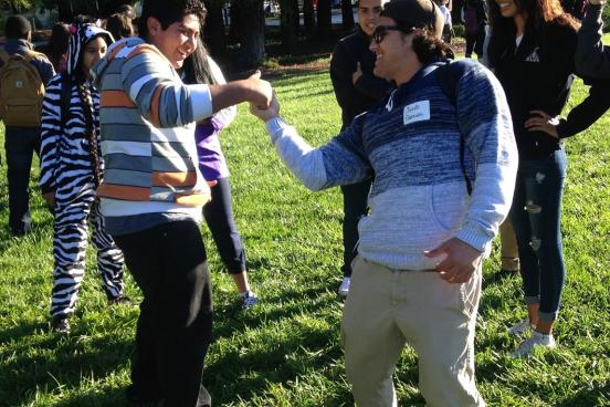An SSU student engages RUP students with an activity.