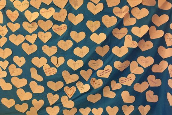 Paper hearts attached to a blue backdrop