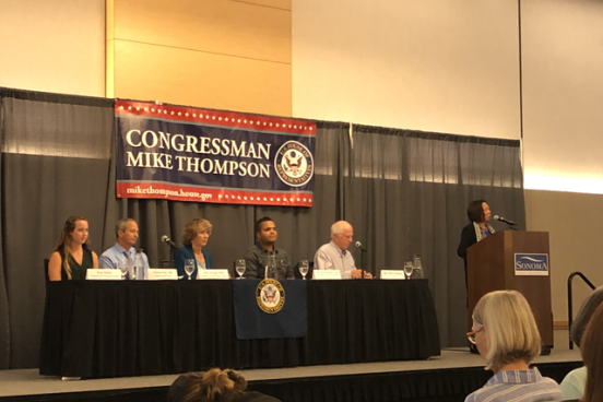Judy Sakaki welcoming Congressman Mike Thompson and the panel to Sonoma State.