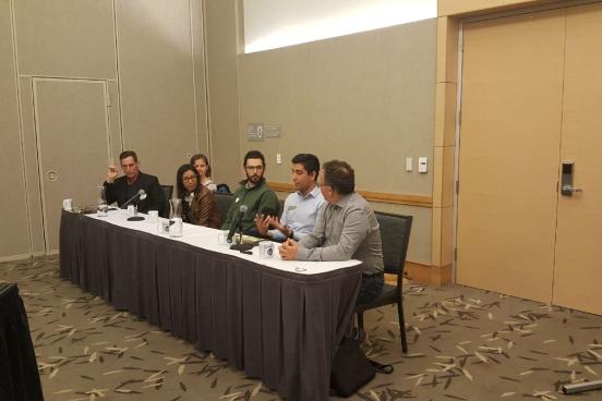 A panel of people sitting at a table