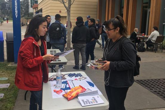 Jackeline giving a student more information on what the Peace Corps entails
