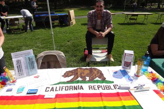 Javier Rivera, Outreach Coordinator tabling for the Service and Internship Fair.