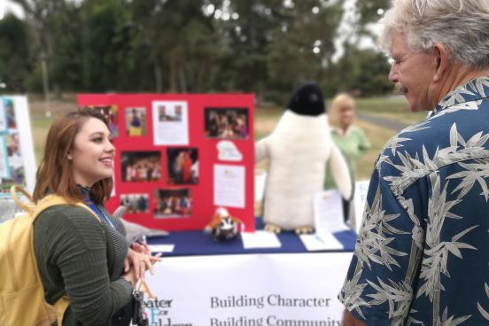 Student and community partner talking about volunteer opportunities.
