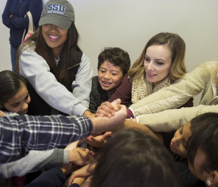 A group of students holding hands