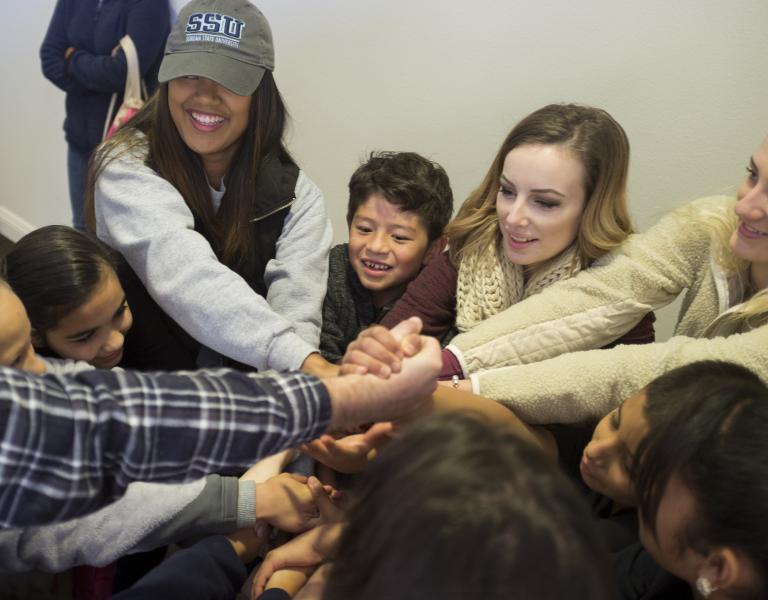 A group of students holding hands