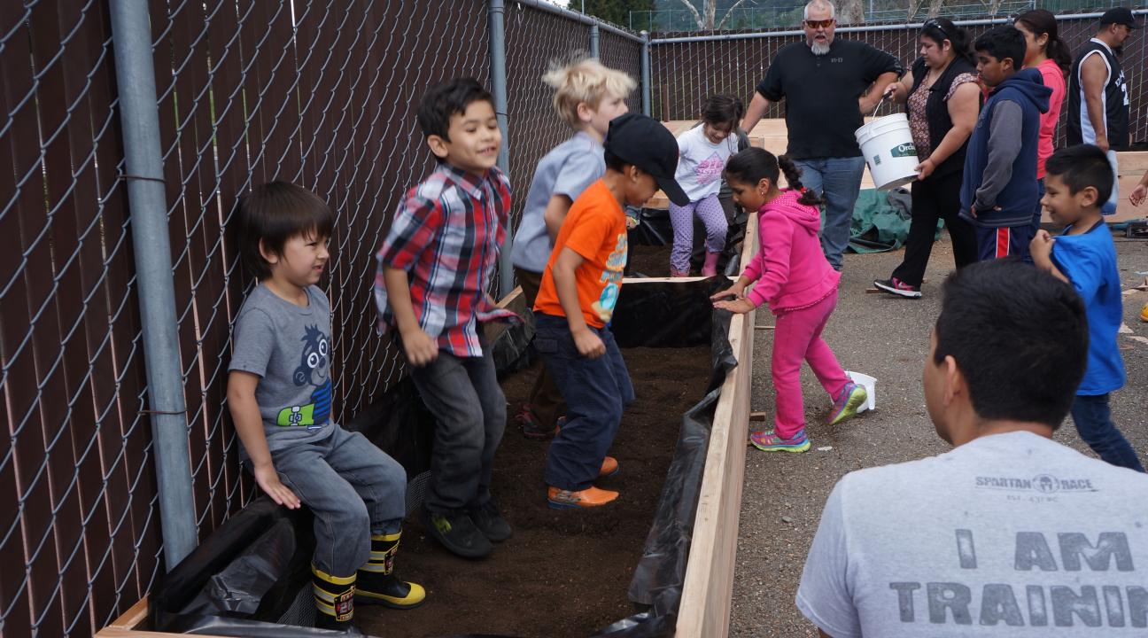 Kids helping build the garden