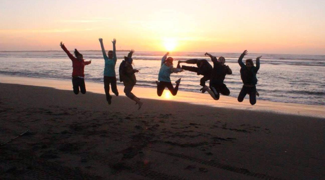 Jumping on the beach at sunset