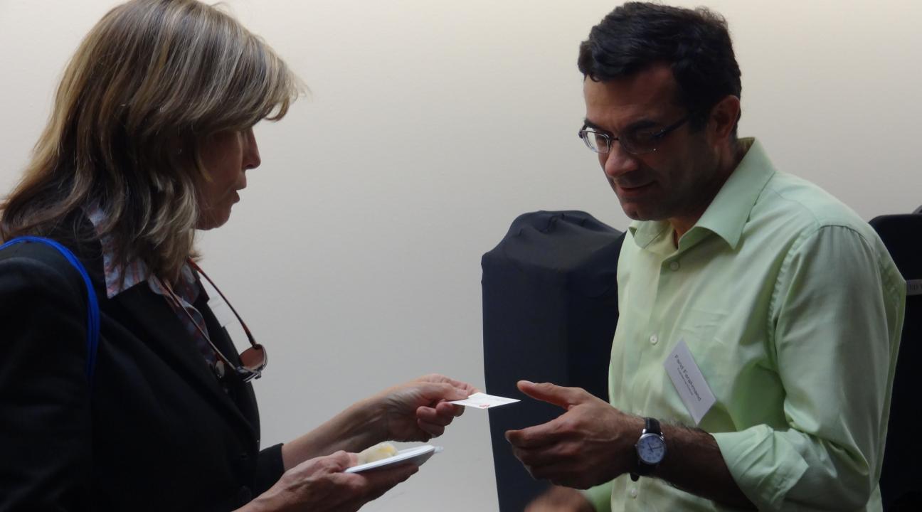 Community partner Gretchen Werner and faculty member Farid Farahmand networking.
