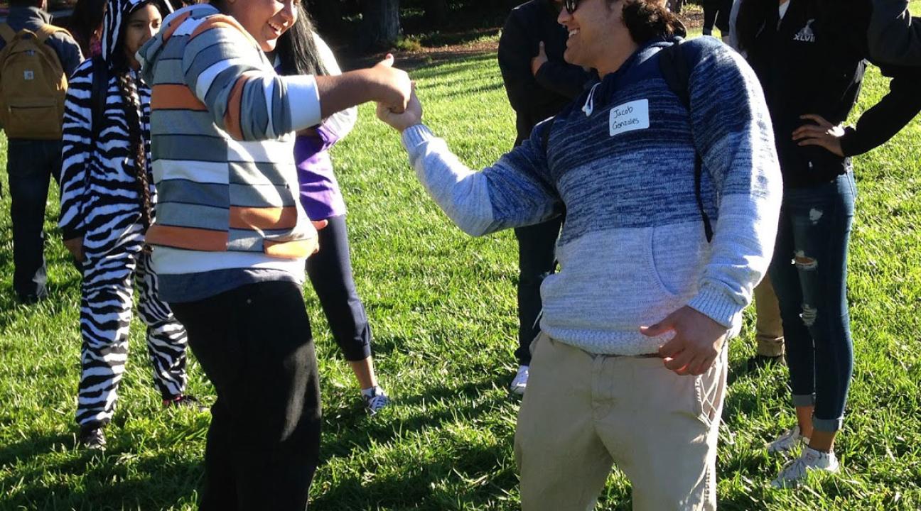 An SSU student engages RUP students with an activity.