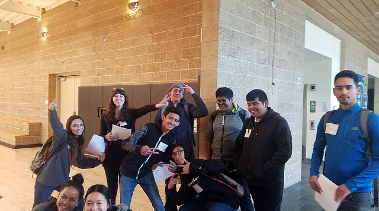 Students pose for a silly photo in the doorway of the basketball court