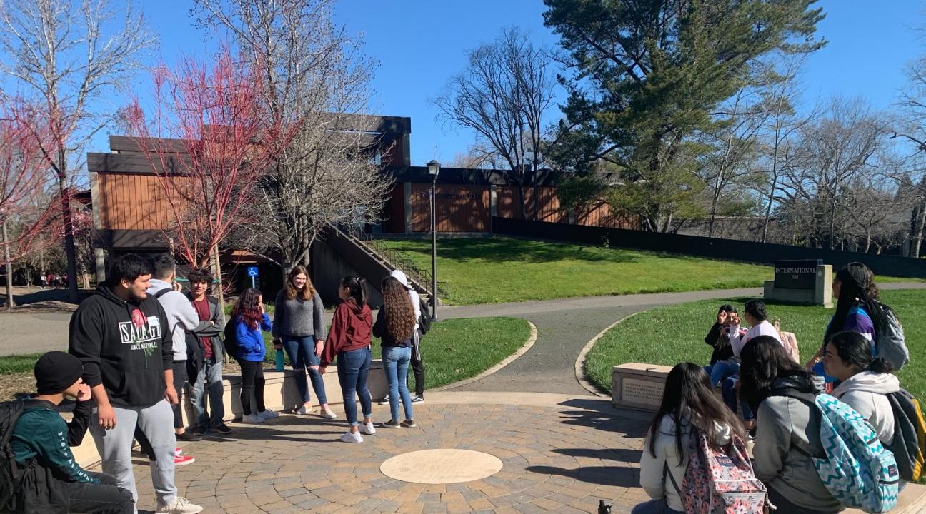 The students are seen enjoying the nice weather, talking about their experience so far at Discovery Day. 