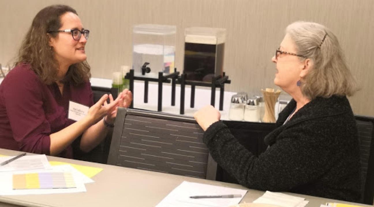 Aja LaDuke chatting at conference