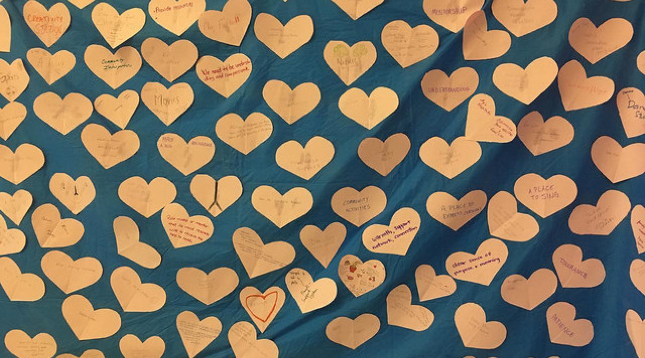 Paper hearts attached to a blue backdrop
