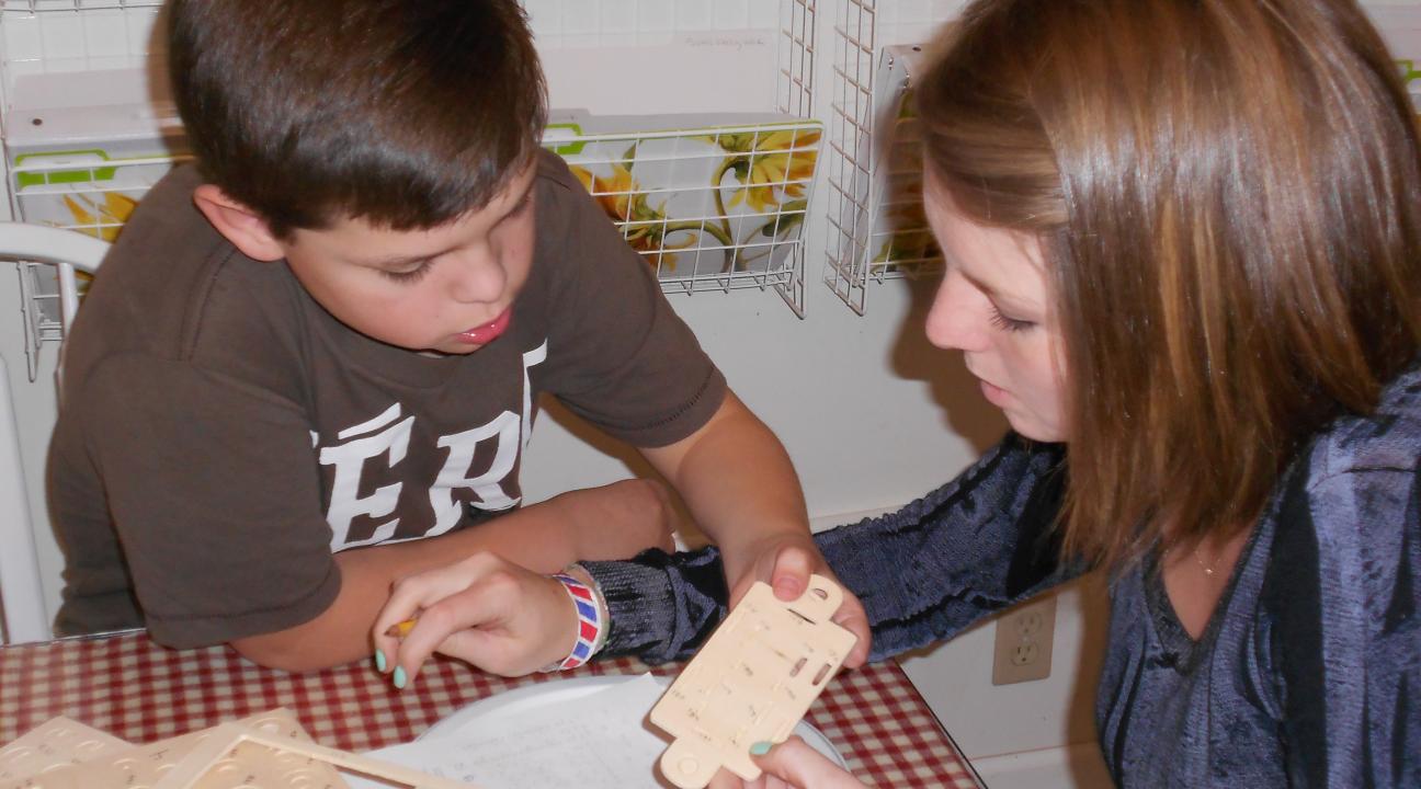 Max Breal and SSU service-learning Anna Gavin work together on a puzzle.