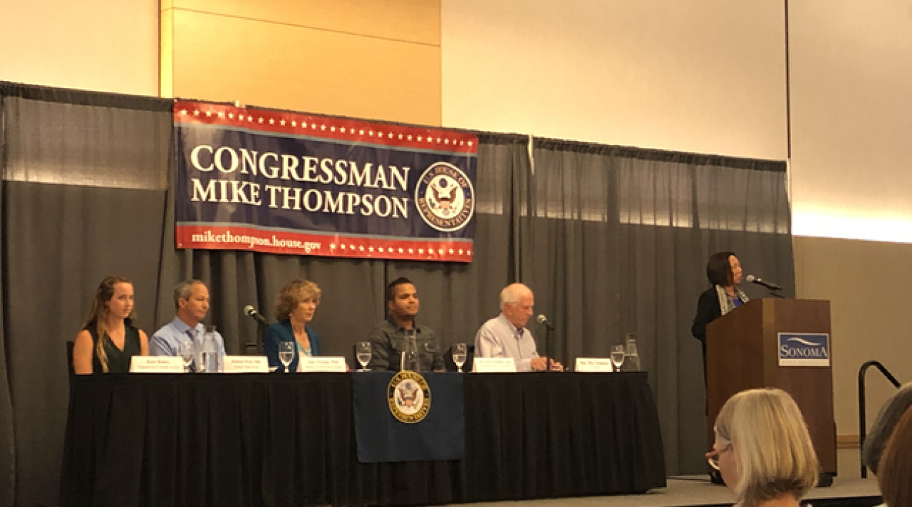Judy Sakaki welcoming Congressman Mike Thompson and the panel to Sonoma State.