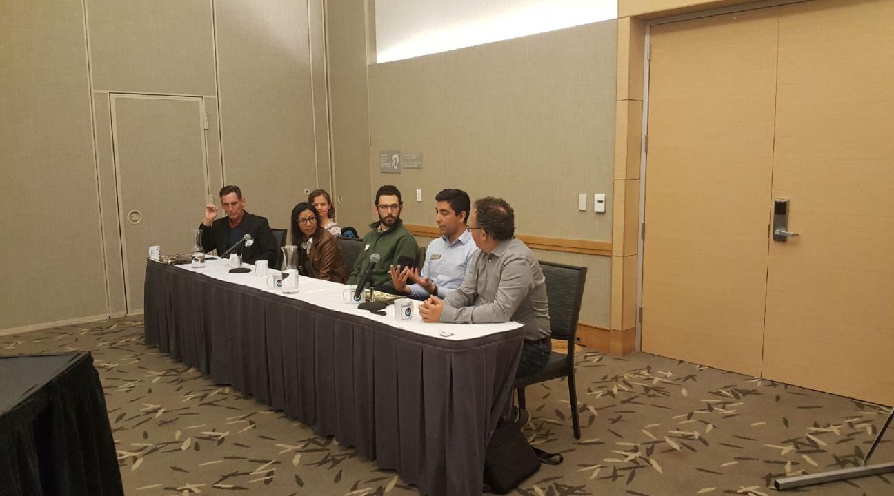 A panel of people sitting at a table