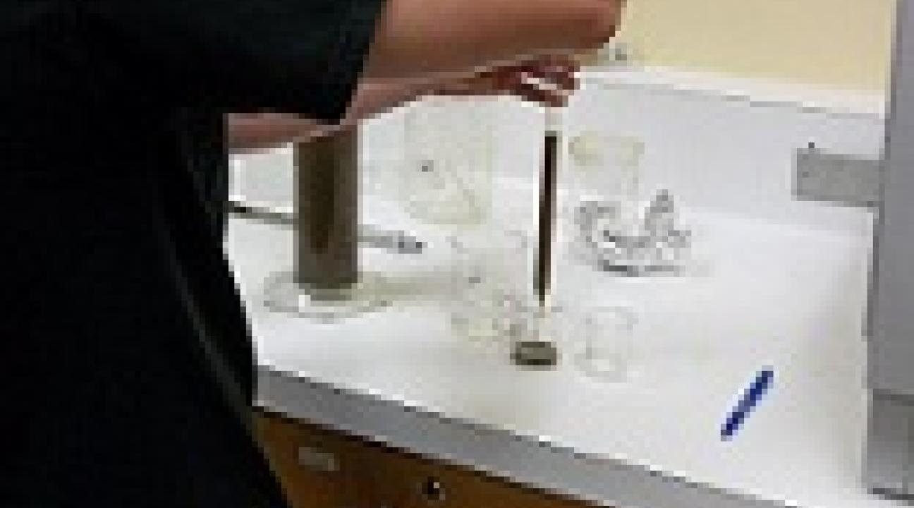 Student pipetting a sample.