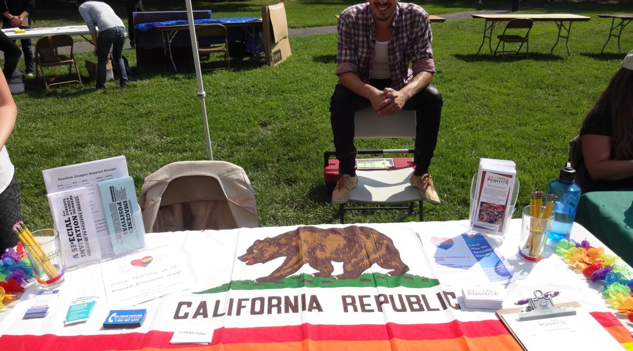Javier Rivera, Outreach Coordinator tabling for the Service and Internship Fair.