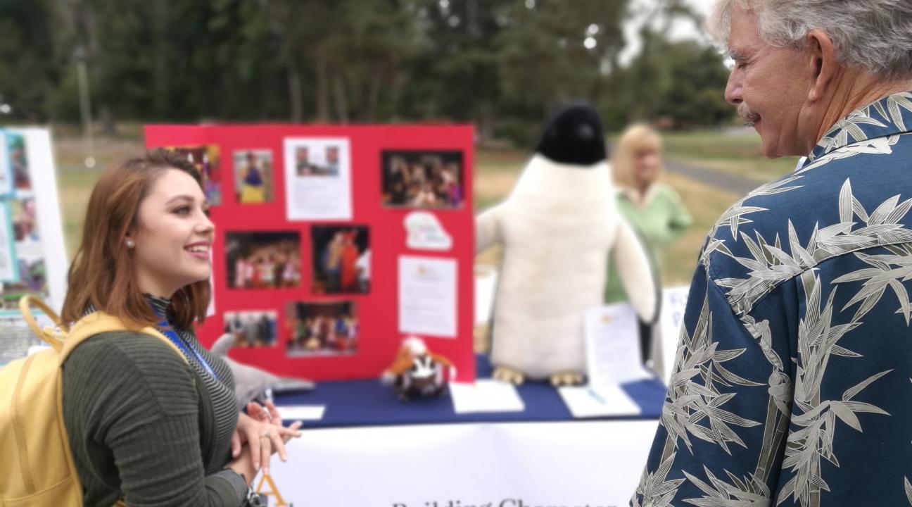 Student and community partner talking about volunteer opportunities.