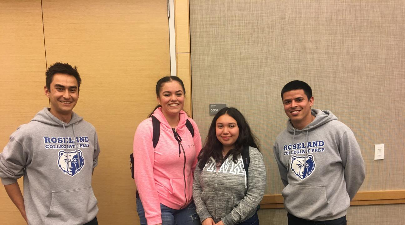 Juniors from Roseland Collegiate Prep smile with their teachers, wearing the gray sweatshirts. 