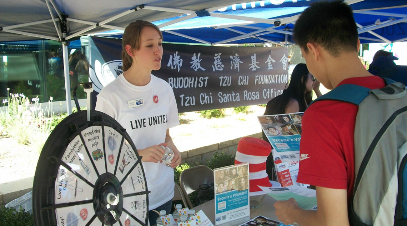 A student checks out a table at the service and internship fair