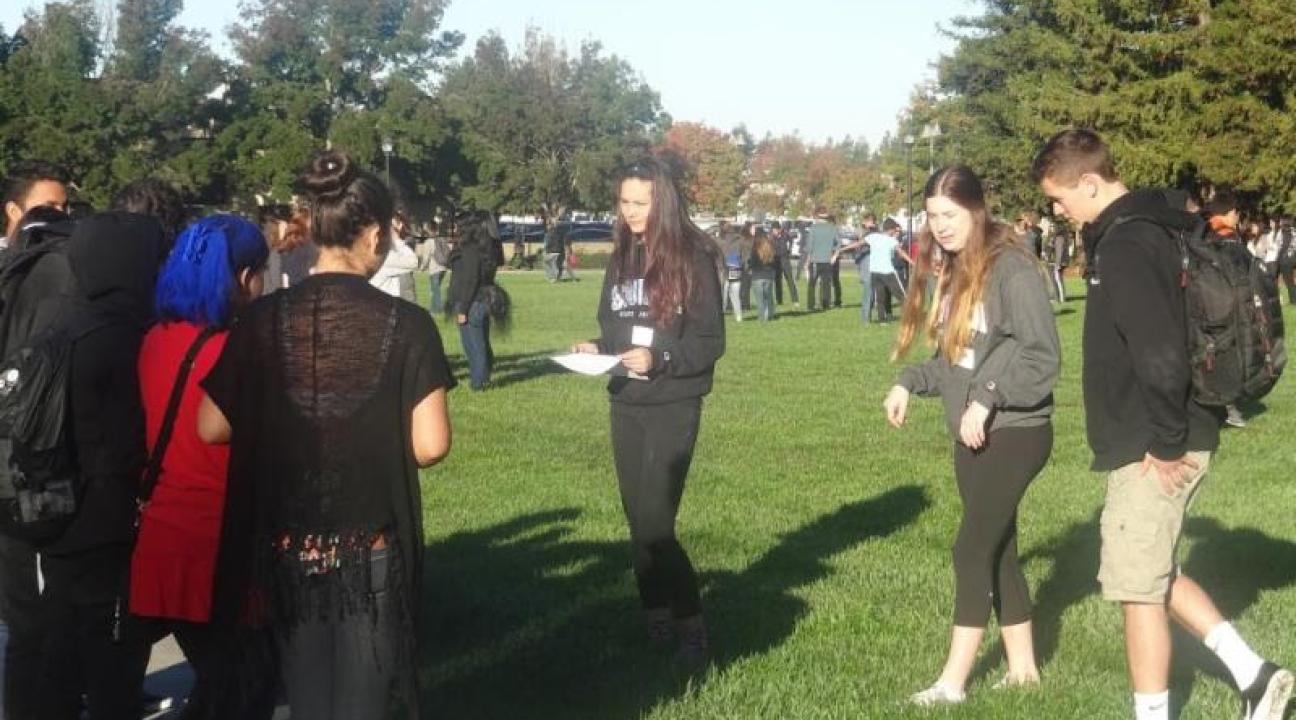 Understanding Media and SSU student, Hanna Green, leading a discussion with a group of local high school freshmen.