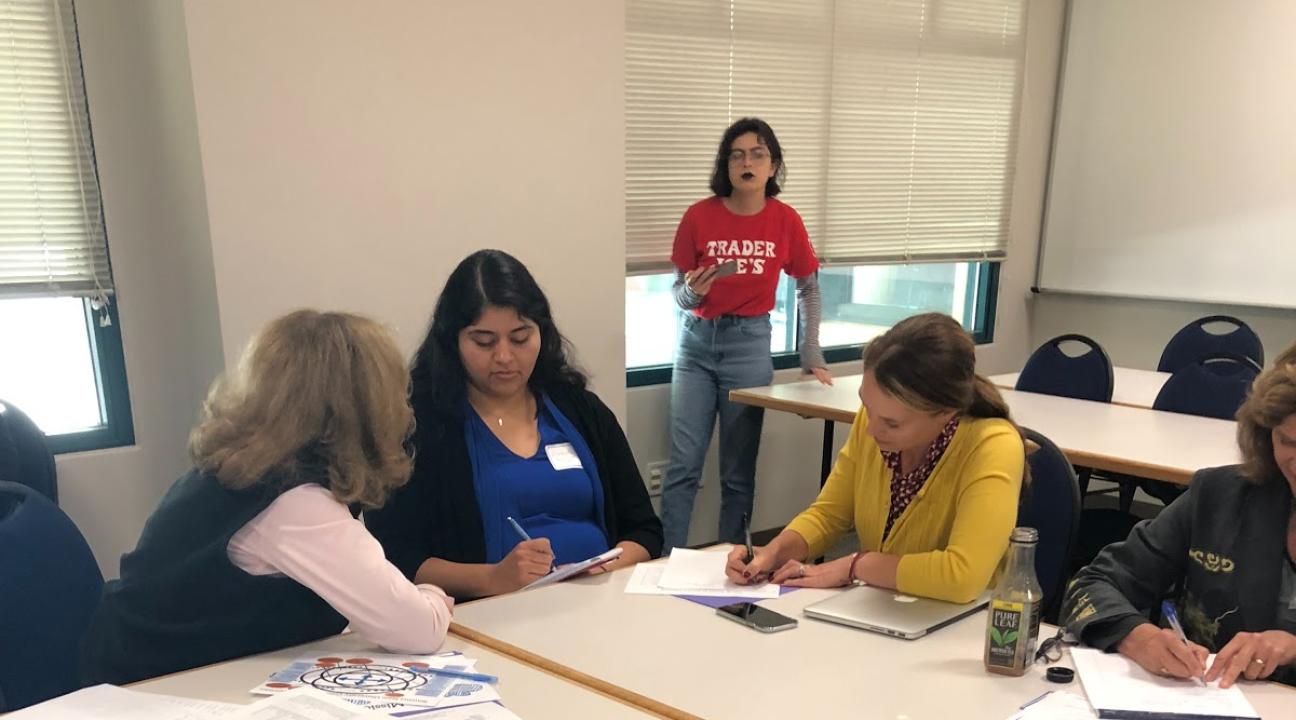 Three participants talking at the tables