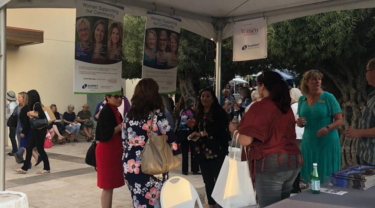 People mingling at the Women Supporting Women tabling