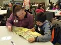 Meadow View student reading to a Sonoma State service-learner.