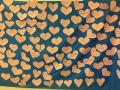 Paper hearts attached to a blue backdrop