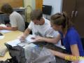 From left to right: Brian Woodward, Stephen Garibaldi, and Caitlyn Yates studying dirt samples in the classroom.