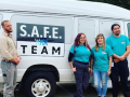4 people standing in front of the SAFE Van outside