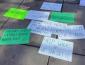 Hand made signs on the ground with messages about access to mental health services