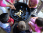 Young kids enjoy bathing a duck with help from SSU students