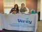 Two women from Verity sit at a presentation table during the internship fair
