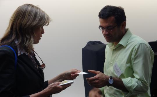 Community partner Gretchen Werner and faculty member Farid Farahmand networking.