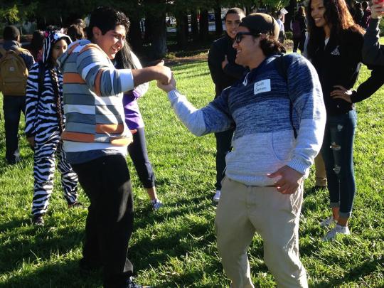 An SSU student engages RUP students with an activity.