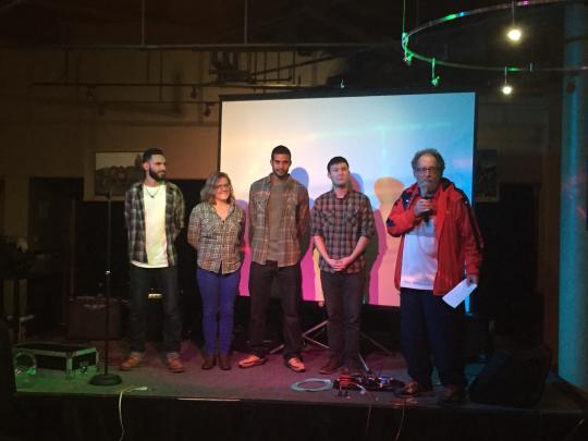 Dustin Dematteo, Allison Jenks, Jamal Edwards, and Tomio Endo on stage with Vice Mayor Jake Mackenzie presenting their mission statement.