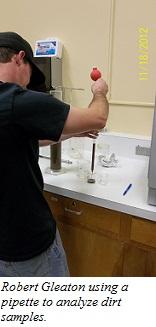 Student pipetting a sample.