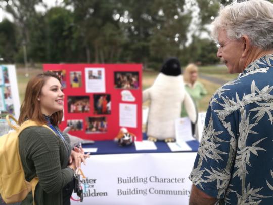 Student and community partner talking about volunteer opportunities.