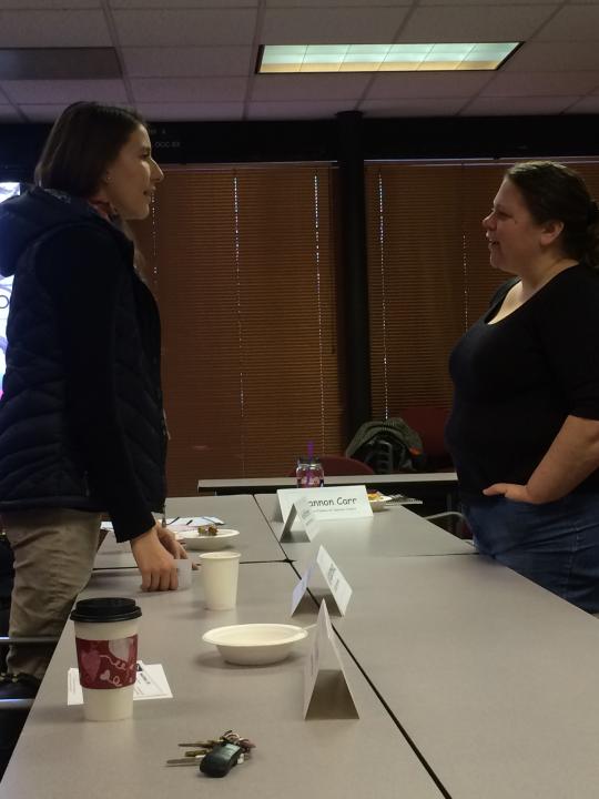 Shannon Carr (right) and a colleague discussing what they learned at the Roundtable.