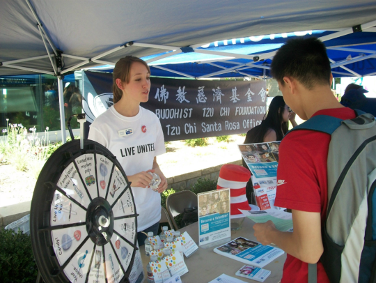 A student checks out a table at the service and internship fair