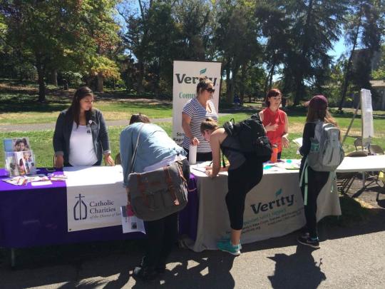 Students signing up for opportunities from Catholic Charities and Verity at the 2016 Fair.