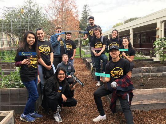 A group of students poses for a photo at Sonoma Serves