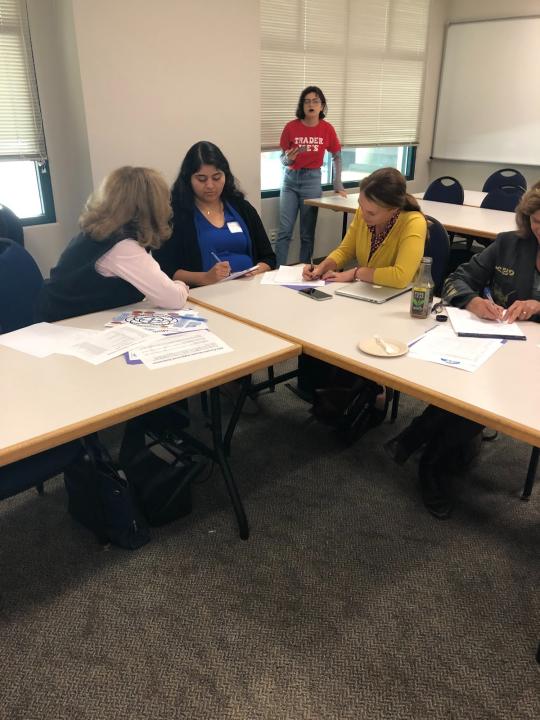 Three participants talking at the tables