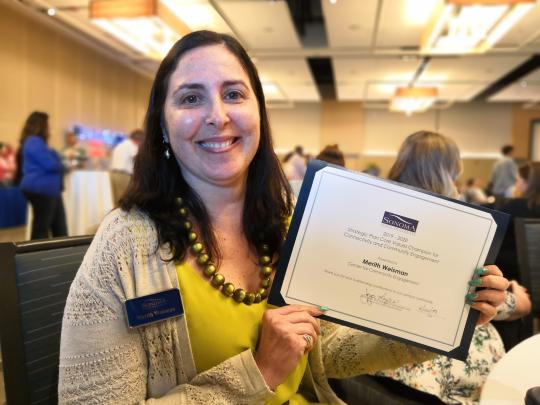 Merith Weisman receiving an award certificate
