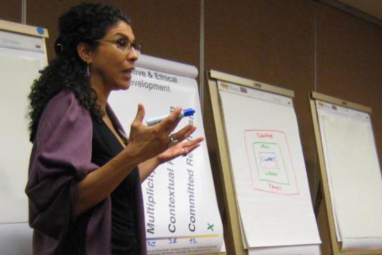 Nanci Luna Jiménez speaking in front of poster presentations