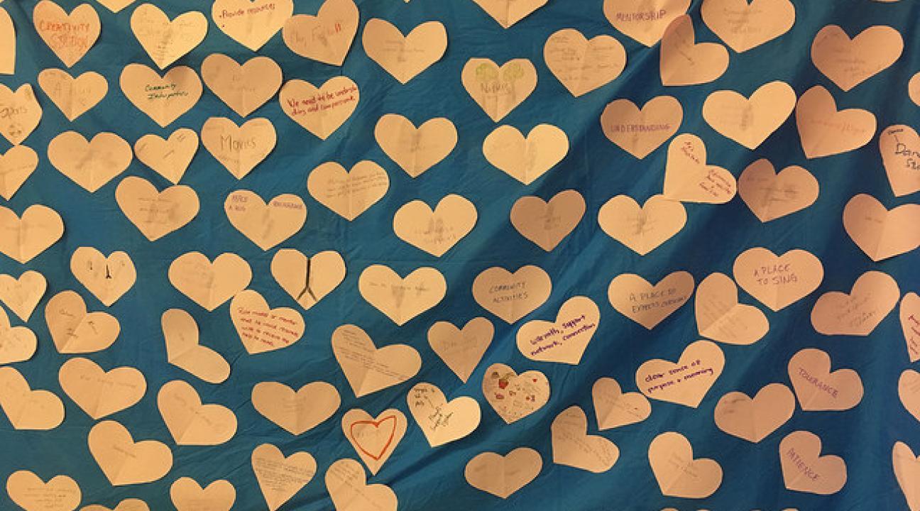 Paper hearts attached to a blue backdrop