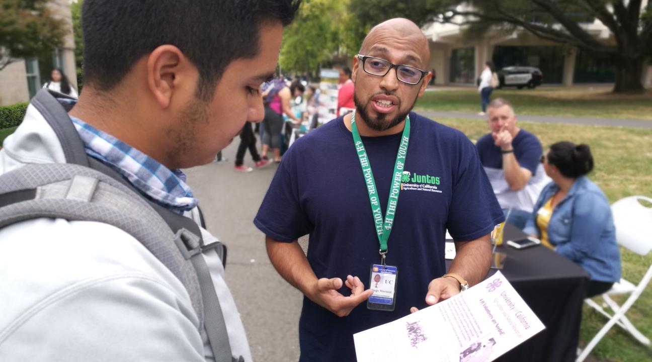 Student talking to 4H representative, Diego Mariscal.